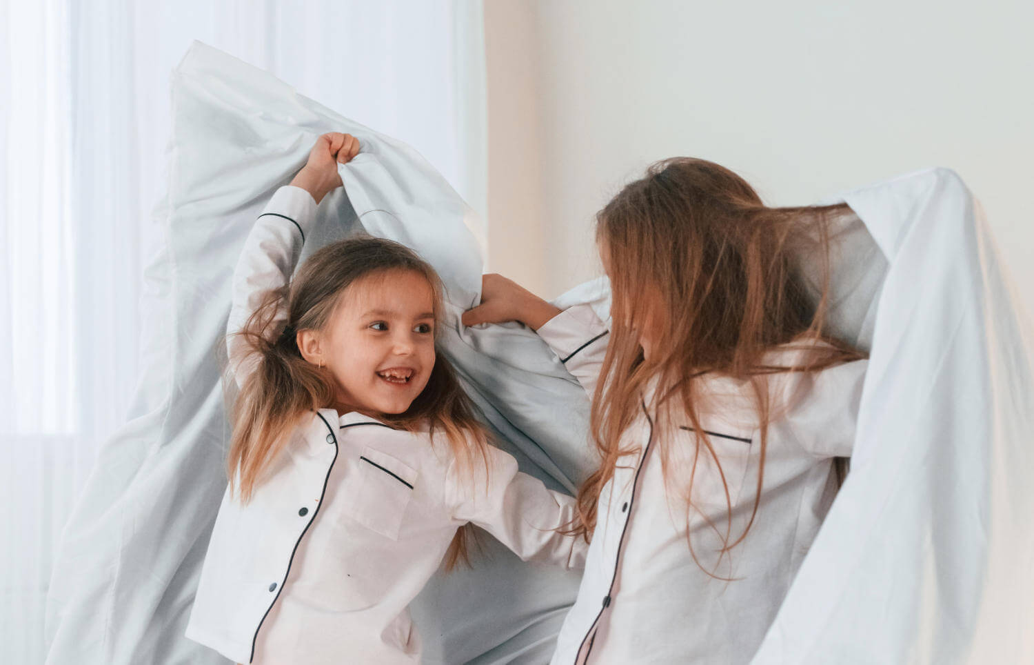 girls-are-bed-two-little-kids-are-playing-having-fun-together-domestic-room.jpg